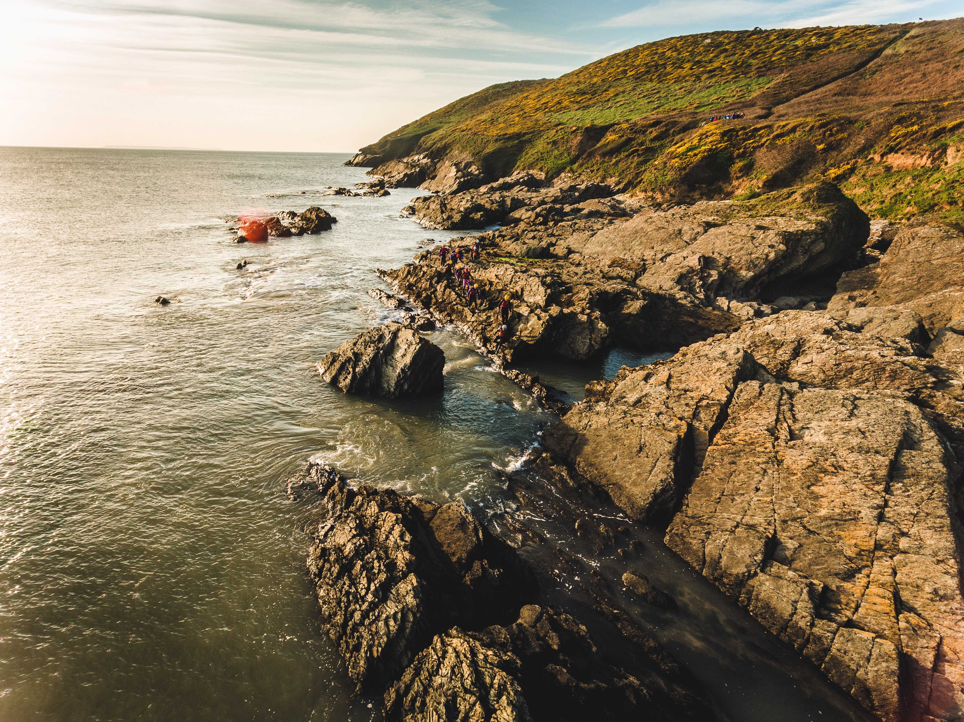 Jagged rocks on the seashore in Devon (Red Morley Hewitt/Unsplash)