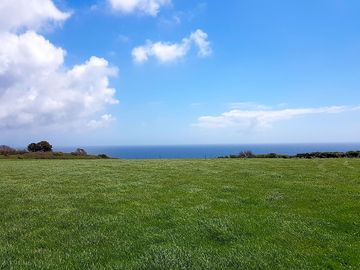 View across field to the coast (added by manager 18 may 2021)