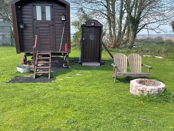 Outside shepherds hut showing the toilet block and seating with fire pit (added by manager 26 apr 2022)