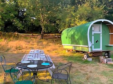 Table outside the green gypsy caravan (added by manager 06 jul 2023)