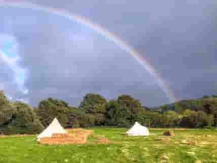 Rainbow over the bell tents