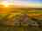 Lanyon Holiday Park: Aerial view of the site out to sea with a great sunset 