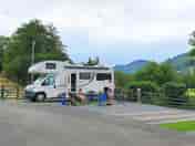 Motorhome parking area in the campsite with the stream behind. (added by visitor 26 Jul 2022)