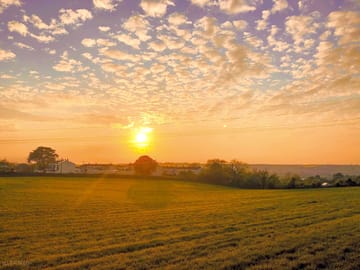 Visitor image of the sunset view overlooking the field next to pitch