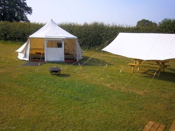 Bell tent and picnic table under awning