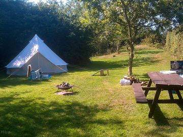 Campers pitching a 5-metre bell tent on pitch 8. We welcome all sort of tents