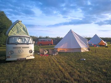 Tent and campervan pitches next to the bell tents