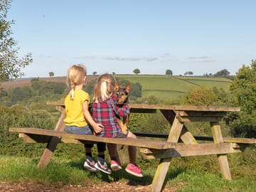 Children sitting on a picnic bench