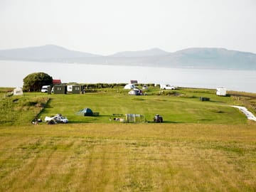 Tent pitches in the foreground and campervan/motorhome pitches in the background