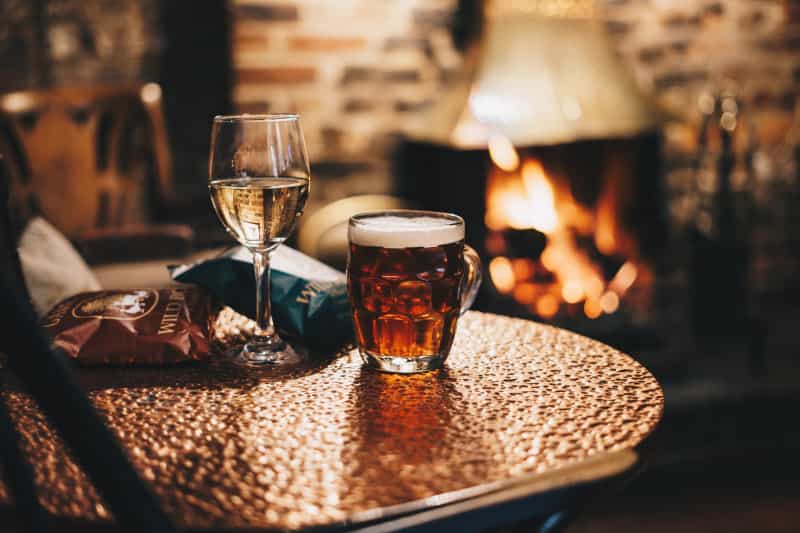 Sip your drinks by a roaring log fire when it’s cold outside (Rick Barrett on Unsplash)