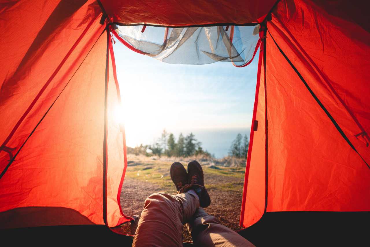 Learn all about how to go camping as a beginner and you’ll soon be putting your feet up with a view (Will Truettner / Unsplash)